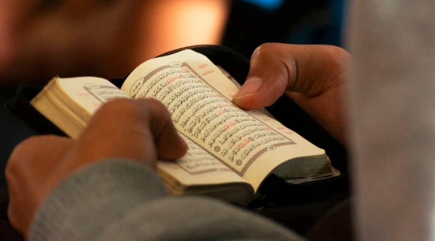 Muslim reading the Quran, reflecting on the Sunnah of Hijama cupping and its spiritual significance in Islam.