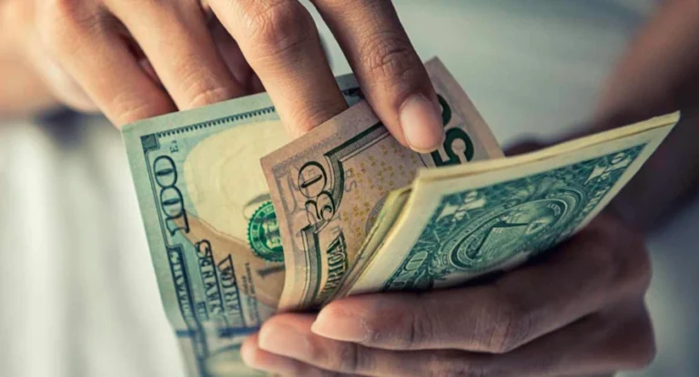 Person holding money, symbolizing earning halal income through Hijama cupping as a meaningful side hustle.